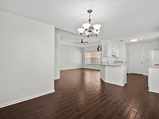 kitchen with dark wood-type flooring, white cabinets, ceiling fan with notable chandelier, and white appliances