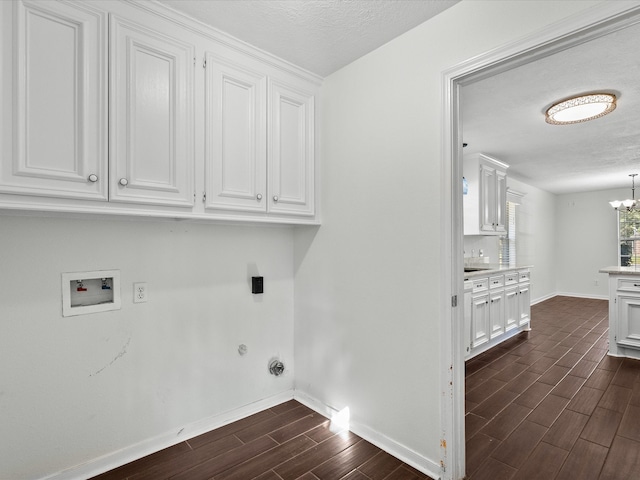 laundry room with a notable chandelier, washer hookup, cabinets, and dark hardwood / wood-style flooring