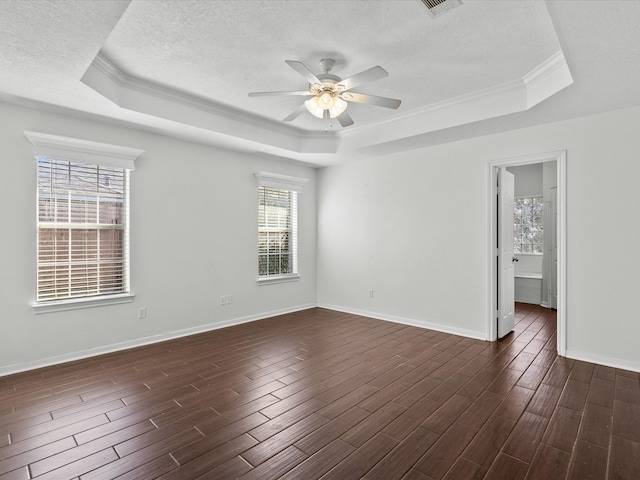 unfurnished room with crown molding, ceiling fan, dark hardwood / wood-style floors, and a raised ceiling