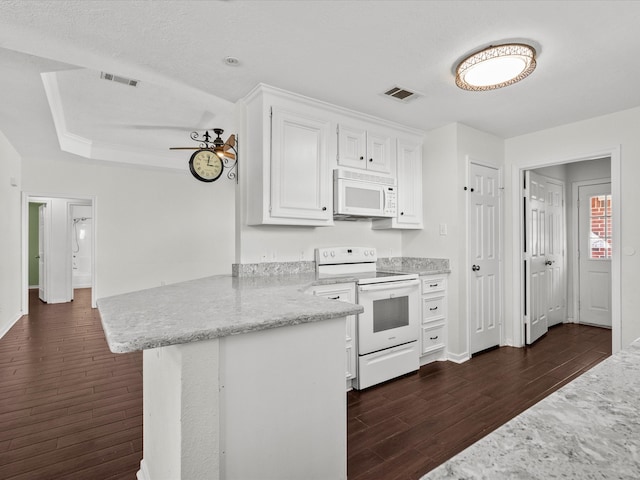 kitchen featuring white appliances, a textured ceiling, dark hardwood / wood-style flooring, kitchen peninsula, and white cabinetry