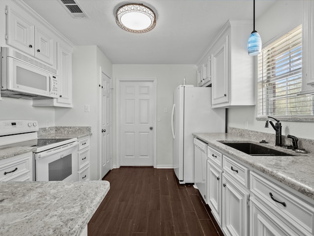 kitchen featuring white cabinetry, dark hardwood / wood-style floors, pendant lighting, sink, and white appliances