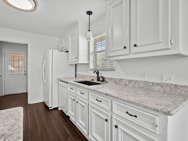 kitchen featuring sink, dishwasher, hanging light fixtures, white cabinetry, and dark wood-type flooring