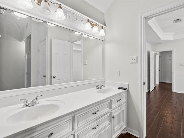 bathroom with vanity, ornamental molding, and hardwood / wood-style floors