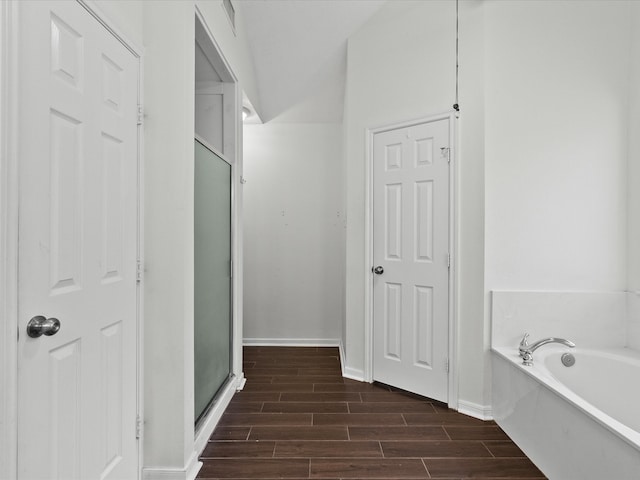 bathroom with hardwood / wood-style floors and plus walk in shower