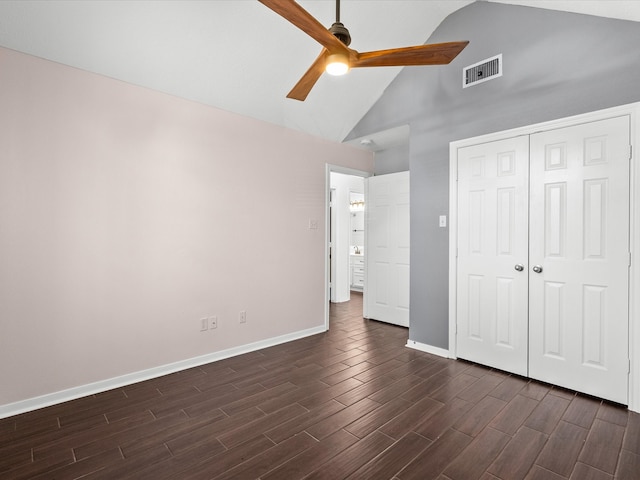 unfurnished bedroom featuring a closet, dark hardwood / wood-style floors, high vaulted ceiling, and ceiling fan