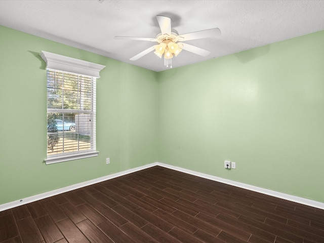 unfurnished room with ceiling fan, a textured ceiling, and dark hardwood / wood-style flooring