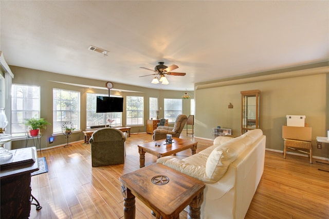 living room with ceiling fan, light hardwood / wood-style flooring, and plenty of natural light