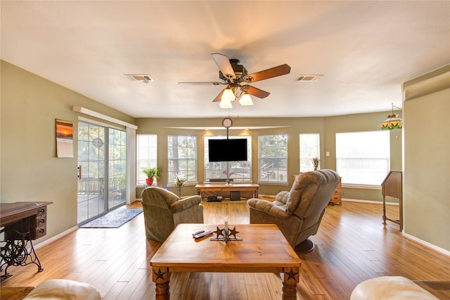 living room featuring light hardwood / wood-style flooring and ceiling fan