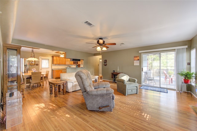 living room featuring light wood-type flooring and ceiling fan