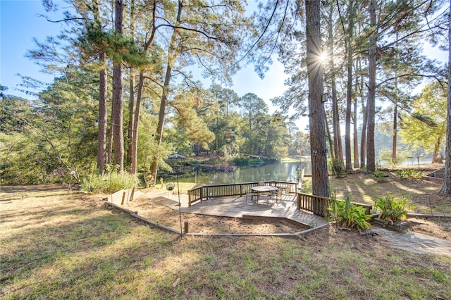 view of yard with a deck with water view