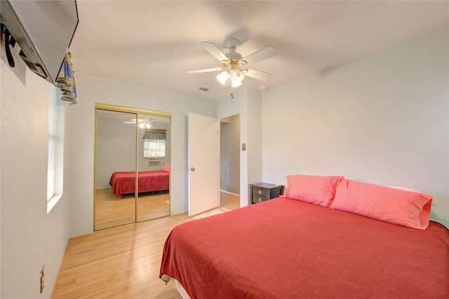 bedroom with a closet, light wood-type flooring, and ceiling fan