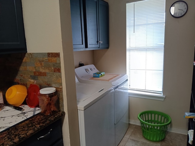 laundry room with washer and dryer, light tile patterned floors, and cabinets