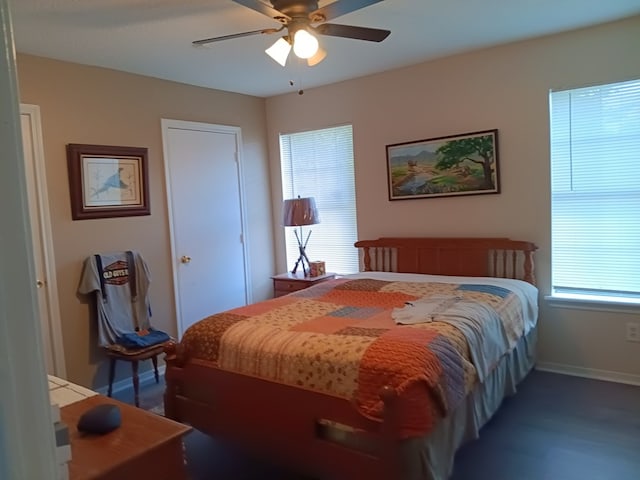 bedroom with ceiling fan and multiple windows