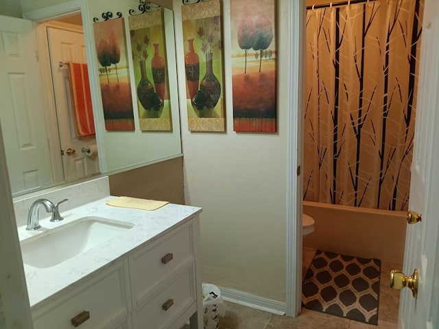 full bathroom featuring vanity, shower / bath combo with shower curtain, toilet, and tile patterned floors