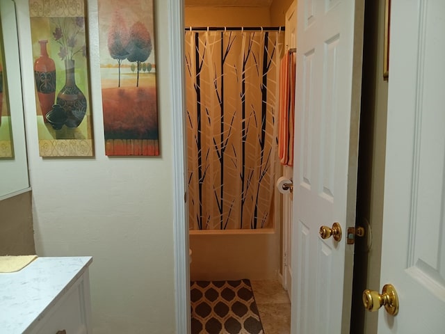 bathroom with vanity, shower / bath combo with shower curtain, and tile patterned flooring