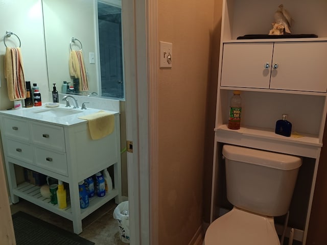 bathroom with vanity, toilet, and tile patterned flooring