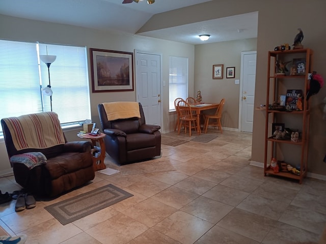 tiled living room featuring lofted ceiling and a healthy amount of sunlight