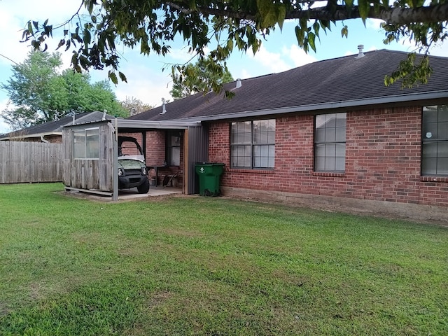 rear view of property featuring a patio area and a lawn