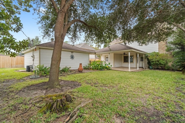 rear view of house with a yard, a patio, and ceiling fan