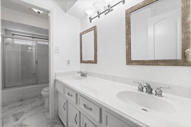 full bathroom with vanity, toilet, and combined bath / shower with glass door