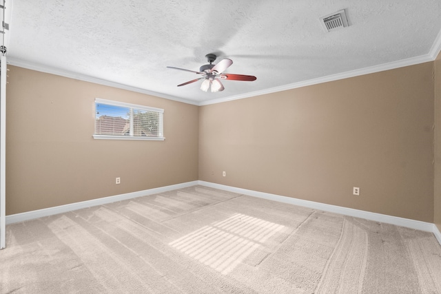 carpeted spare room featuring ornamental molding, a textured ceiling, and ceiling fan