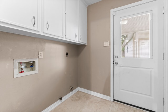 laundry room featuring hookup for an electric dryer, washer hookup, light tile patterned floors, and cabinets