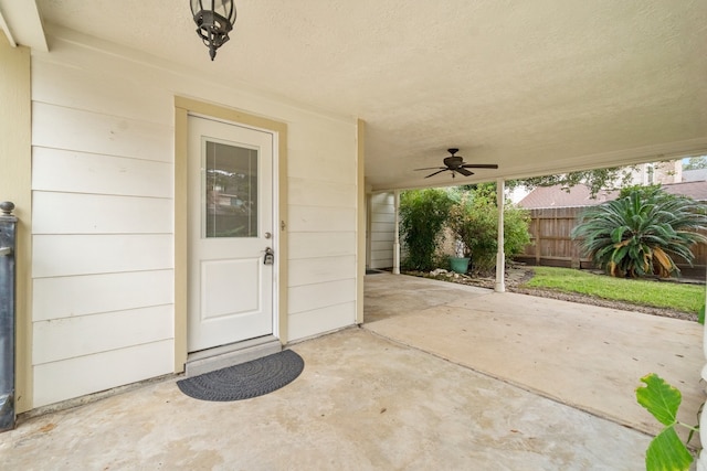 property entrance featuring a patio and ceiling fan