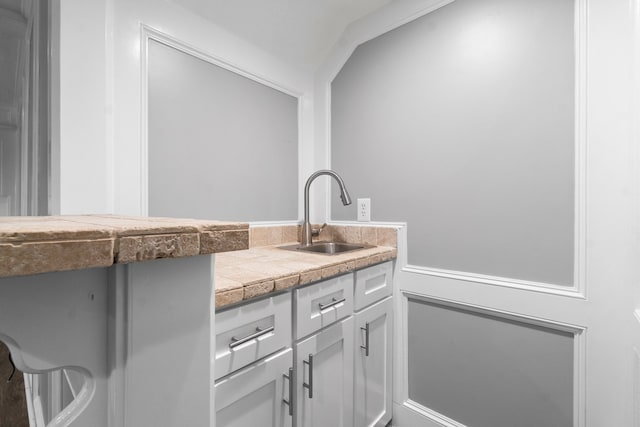 bathroom with vanity and lofted ceiling