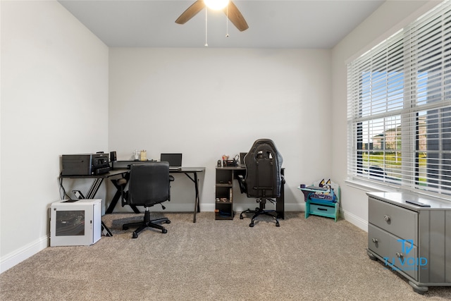 home office featuring light carpet and ceiling fan