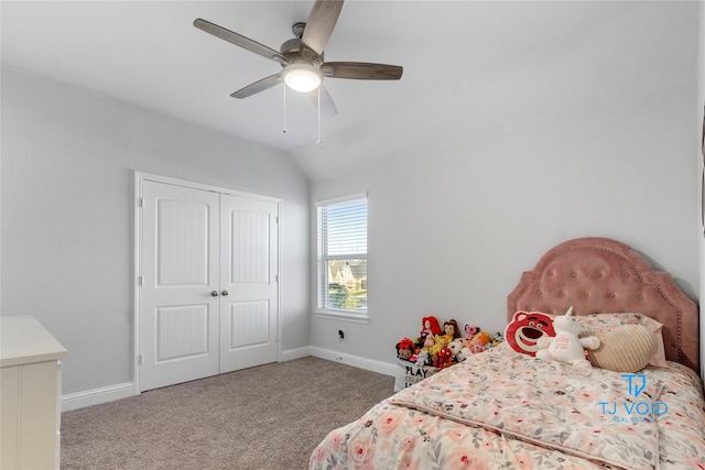 carpeted bedroom with a closet, vaulted ceiling, and ceiling fan