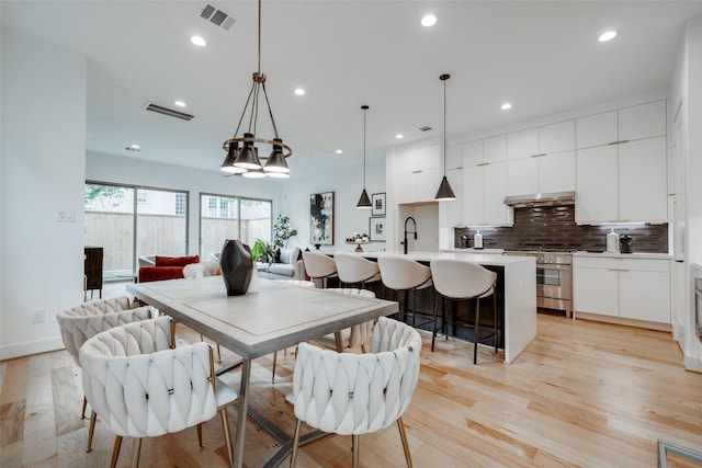 dining space featuring recessed lighting, visible vents, and light wood finished floors