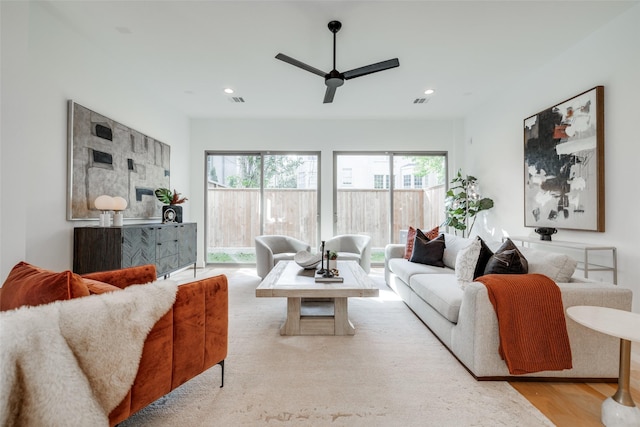 living area with recessed lighting, wood finished floors, and ceiling fan