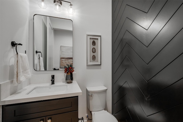 bathroom with toilet and vanity