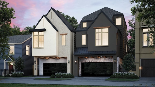 view of front of property featuring a garage, brick siding, and driveway