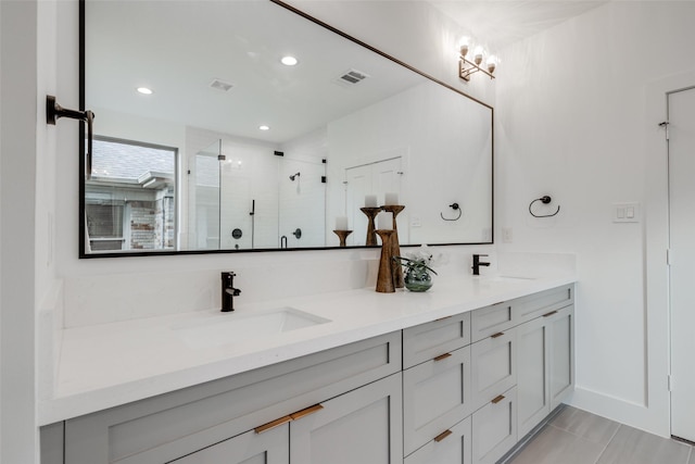 full bathroom with visible vents, a stall shower, a sink, recessed lighting, and double vanity