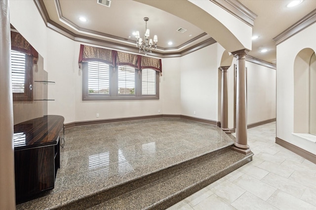 interior space featuring ornate columns, ornamental molding, a raised ceiling, and a notable chandelier