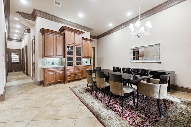 tiled dining area featuring a chandelier and ornamental molding