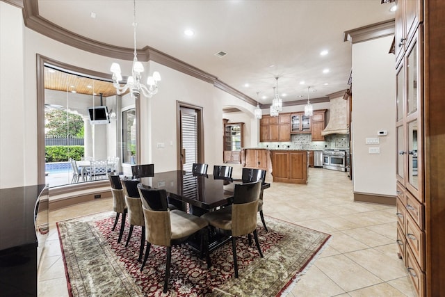 tiled dining space featuring a chandelier and crown molding