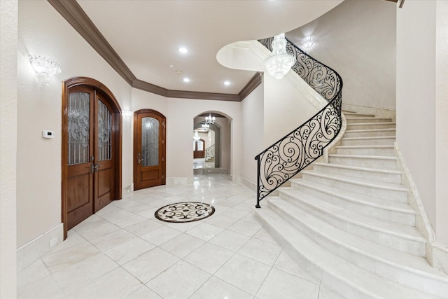 tiled foyer entrance featuring ornamental molding