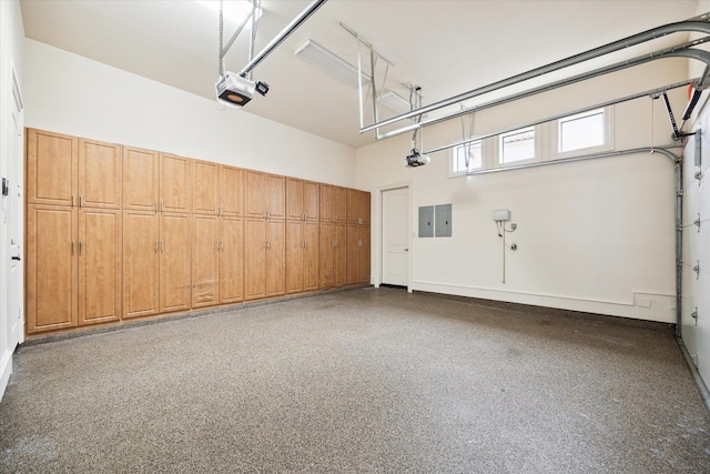 garage with a garage door opener and electric panel