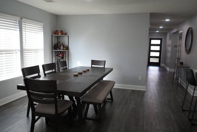 dining area featuring dark hardwood / wood-style floors and a healthy amount of sunlight