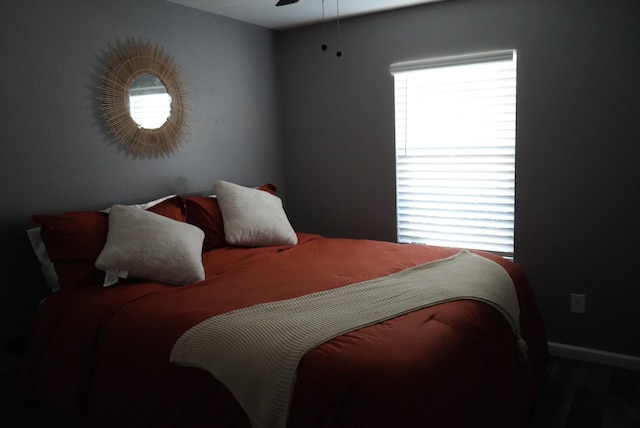 bedroom with hardwood / wood-style flooring and ceiling fan