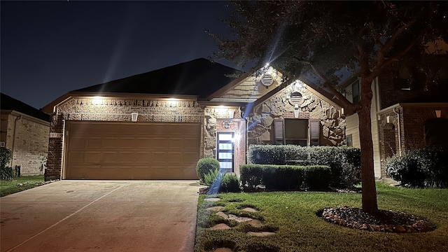 view of front facade with a garage and a lawn