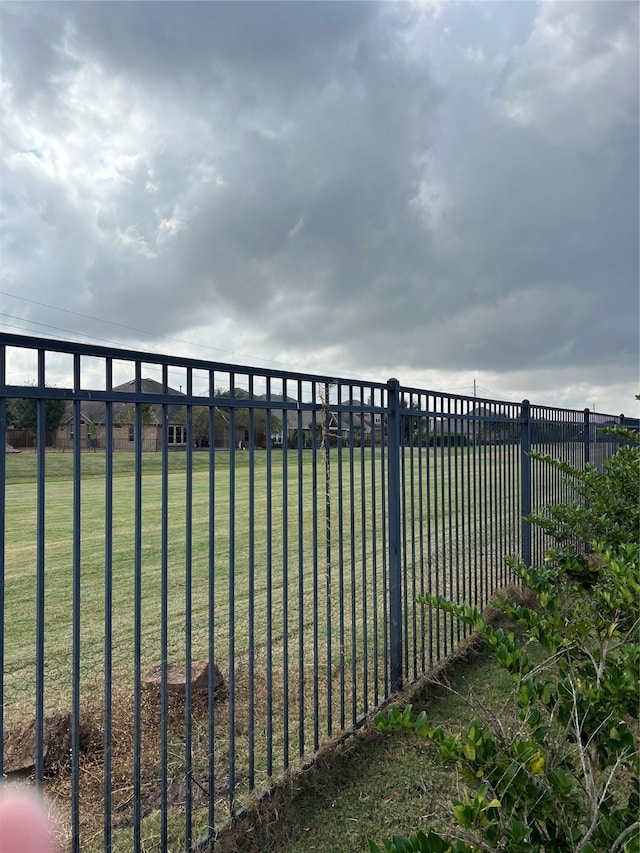 view of gate featuring a lawn