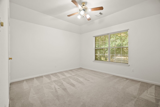 carpeted spare room featuring ceiling fan