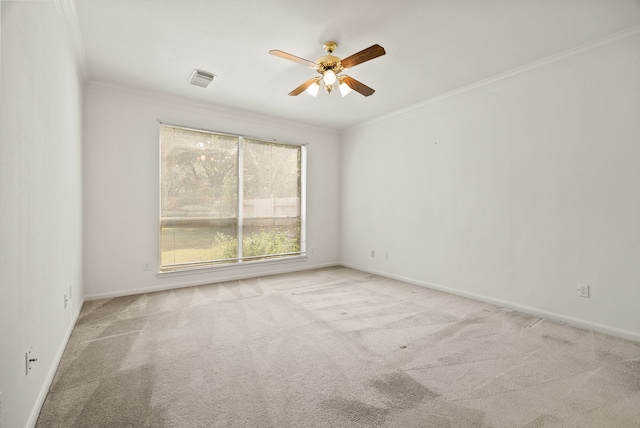 carpeted empty room with ceiling fan and ornamental molding