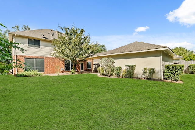 back of house featuring a yard