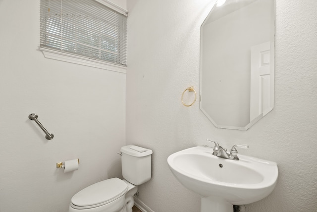 bathroom with toilet and sink