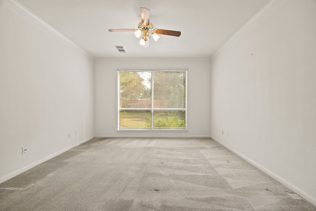 empty room with light carpet, crown molding, and ceiling fan