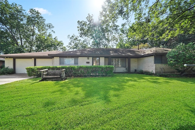 ranch-style home with a front yard and a garage